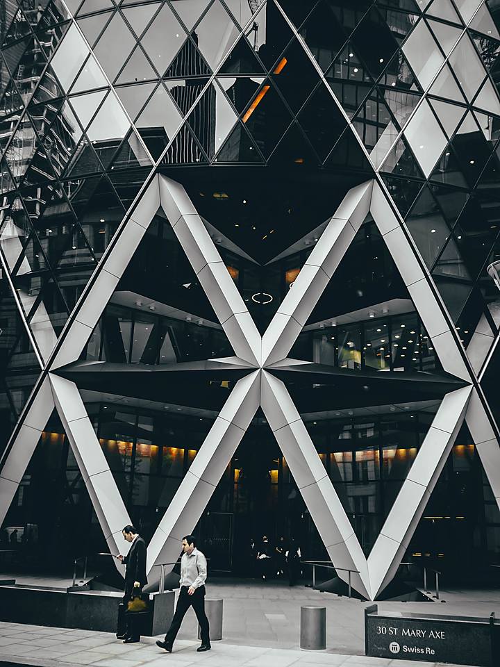 Office tower facade with people walking past